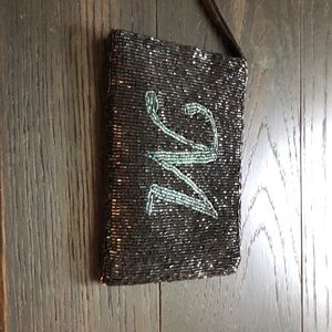 Sequined wristlet with monogram M